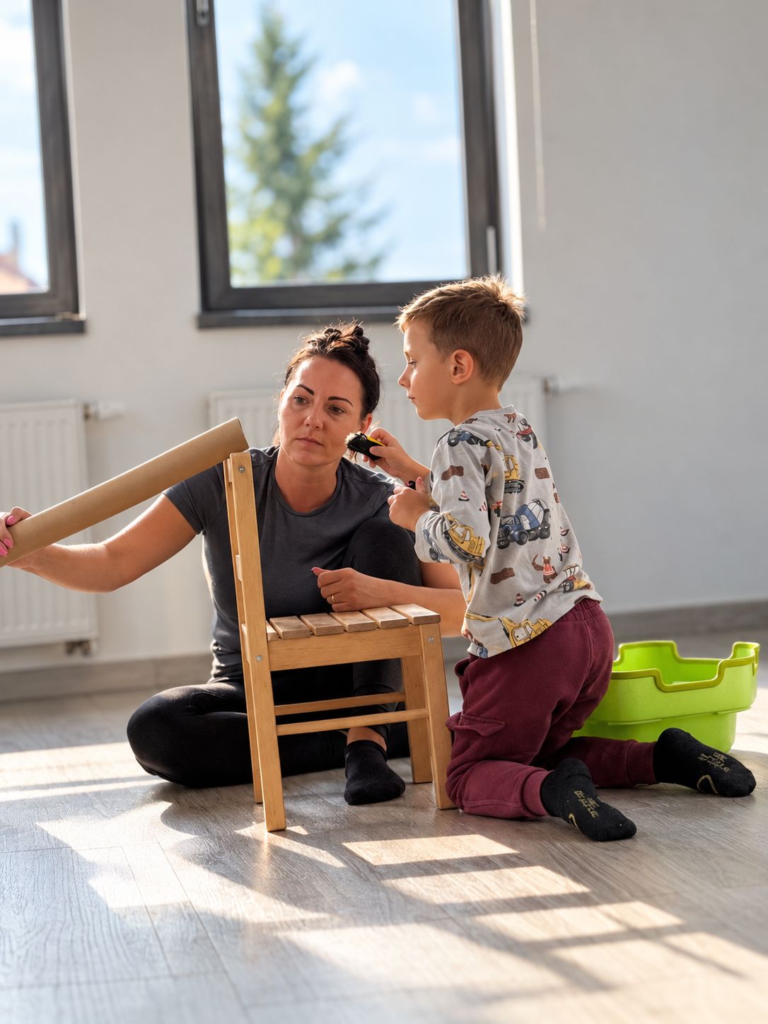 Maminka se synem společně skládají dřevěnou židličku